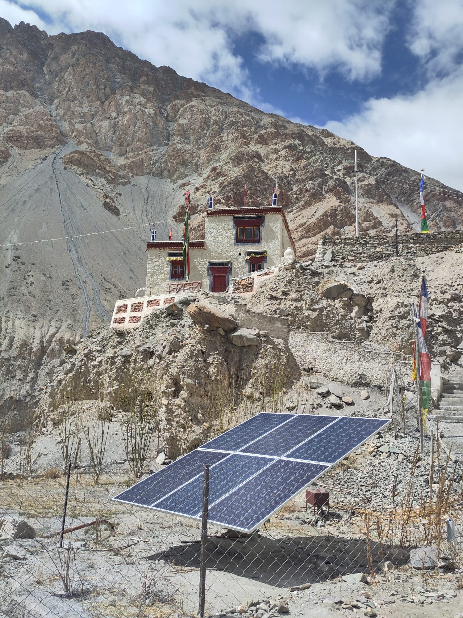 A solar panel beside a traditional Ladakhi house in the mountains